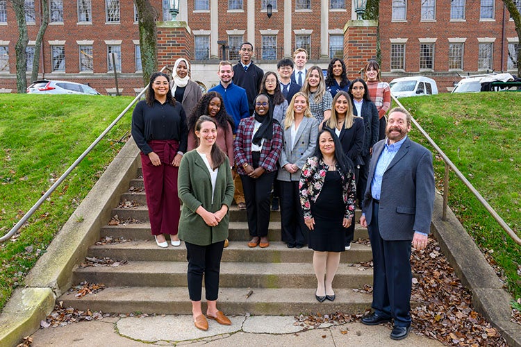 Students and faculty pose together outside of the Medical and Dental Building in Fall 2022