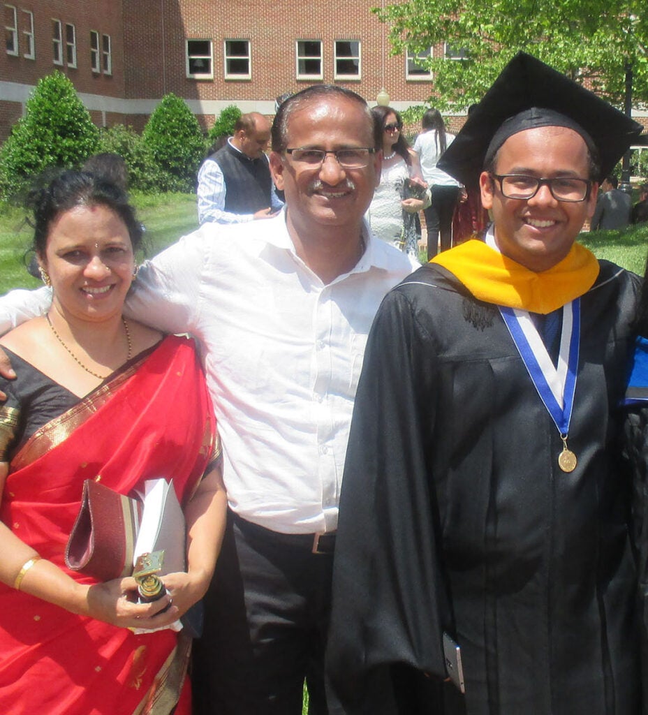 A graduating student with family at 2016 Commencement