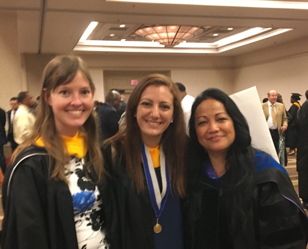 Students pose with Dr. Simbulan-Rosenthal at 2018 Commencement