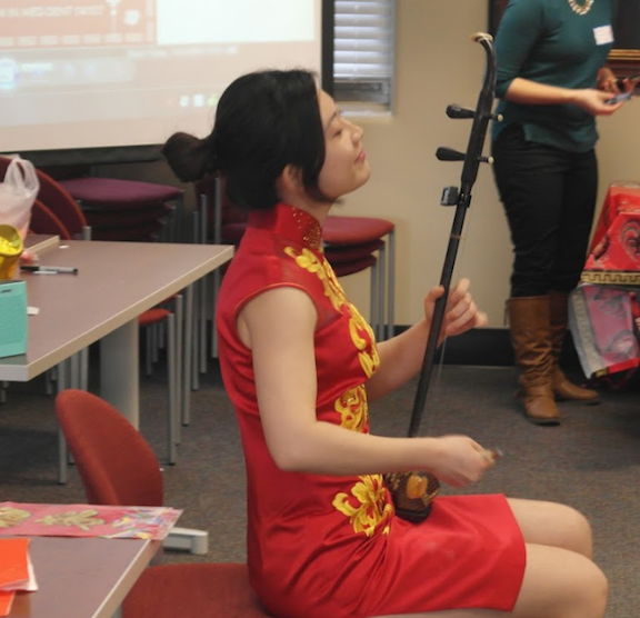A student plays an instrument at Chinese New Year