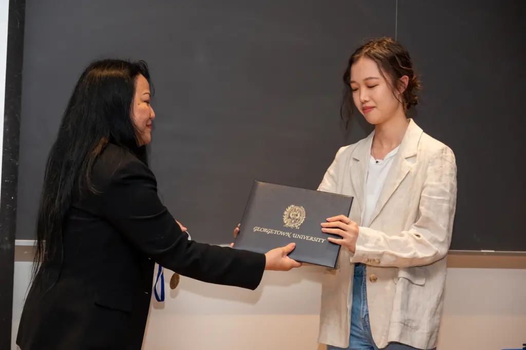 A student receives an award at the Spring 2023 Tropaia Ceremony