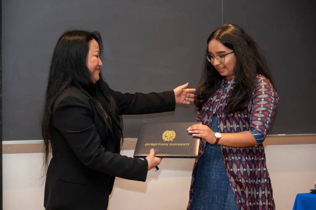 A student receives an award at the Spring 2023 Tropaia Ceremony